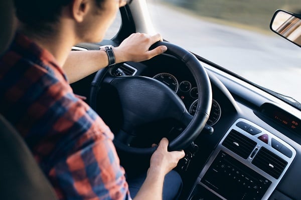 man at the wheel of a car